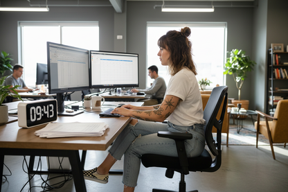 hourly admin work being done by girl in white tshirt and jeand and checjerd vans brown hair tattoood